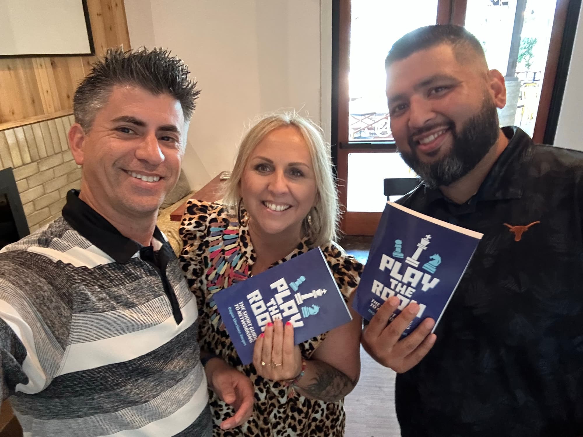 Dagan Martinez-Vargas with a reader holding a copy of Play the Room