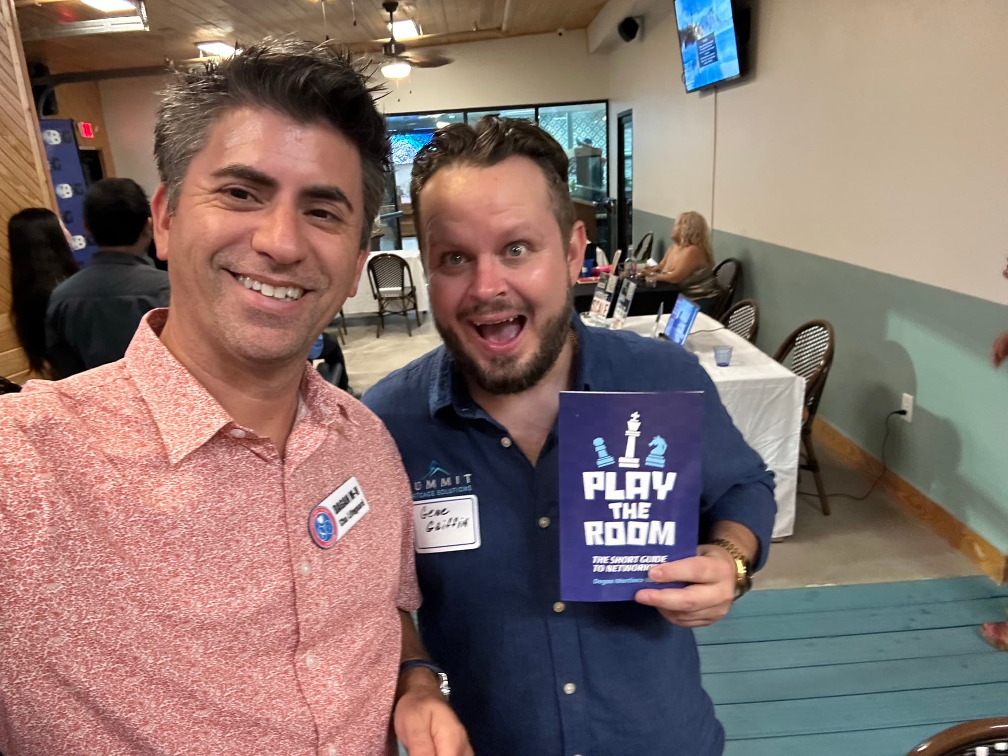 Dagan Martinez-Vargas with a reader holding a copy of Play the Room